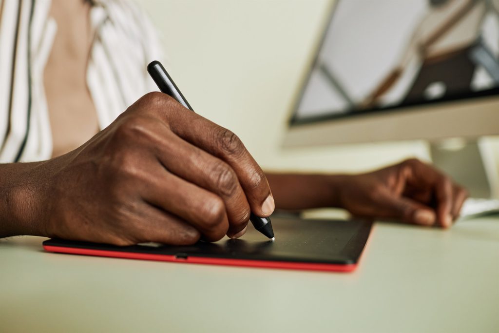 Designer sketching with a stylus on a digital tablet